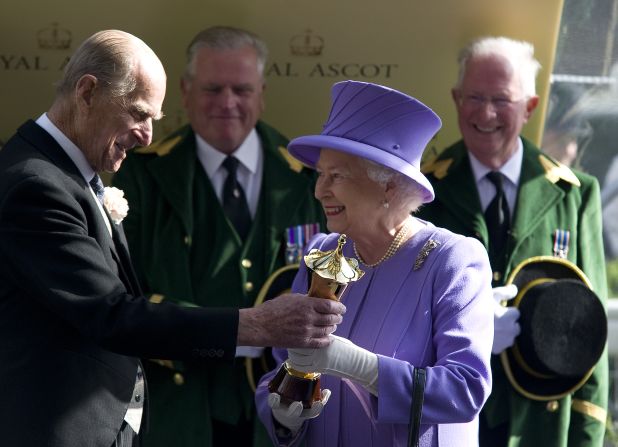 Britain's Queen Elizabeth is a renowned racehorse owner, with her first victory coming in her Coronation year of 1953 when Choir Boy won at Ascot. She is pictured here collecting the Queen's Vase after her horse Estimate triumphed at  Royal Ascot this year -- her 21st win at the prestigious meeting.