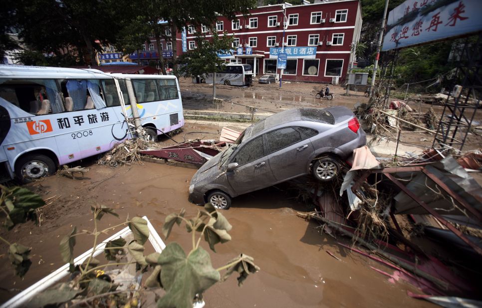 Weekend flooding leaves vehicles tossed about on roads in Laishui, a town in northern China's Hebei province.