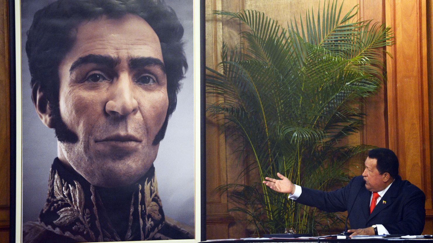 Venezuelan President Hugo Chavez shows a picture with the possible face of Liberator Simon Bolivar, a digital rendering from genetic data.
