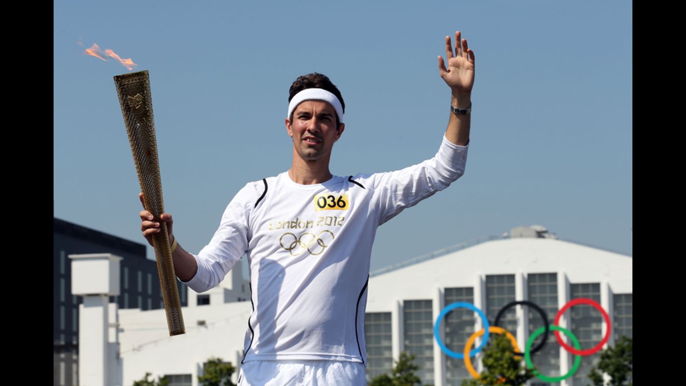 Badminton player Nathan Robertson poses during the handover of the Olympic Torch at Wembley Stadium two days before the Opening Ceremony. 