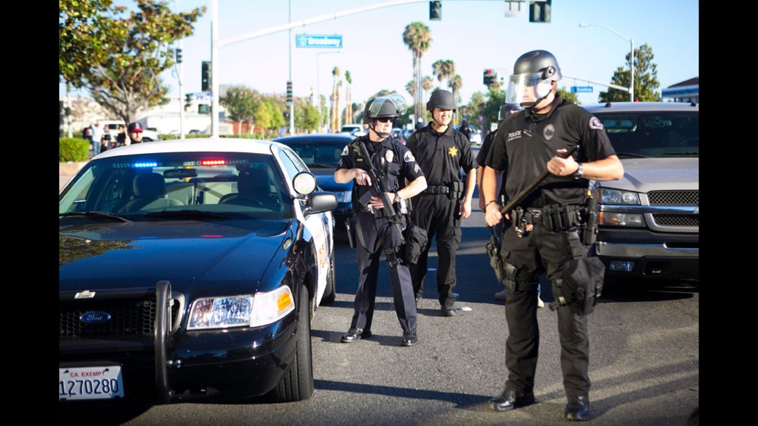 Police stand ready during a protest over the shooting death of Manuel Angel Diaz on Tuesday, July 24, in Anaheim, California. An Anaheim police officer fatally shot Diaz on Saturday, setting off days of protests.