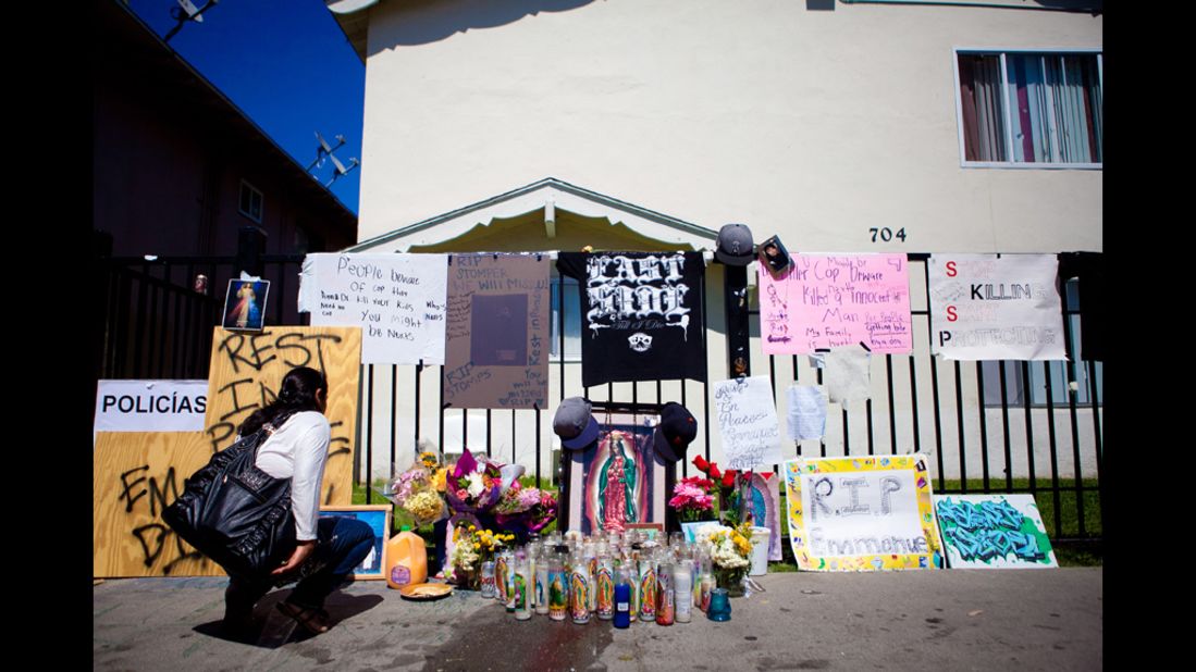 An Anaheim resident pauses at a memorial for Diaz on July 24.