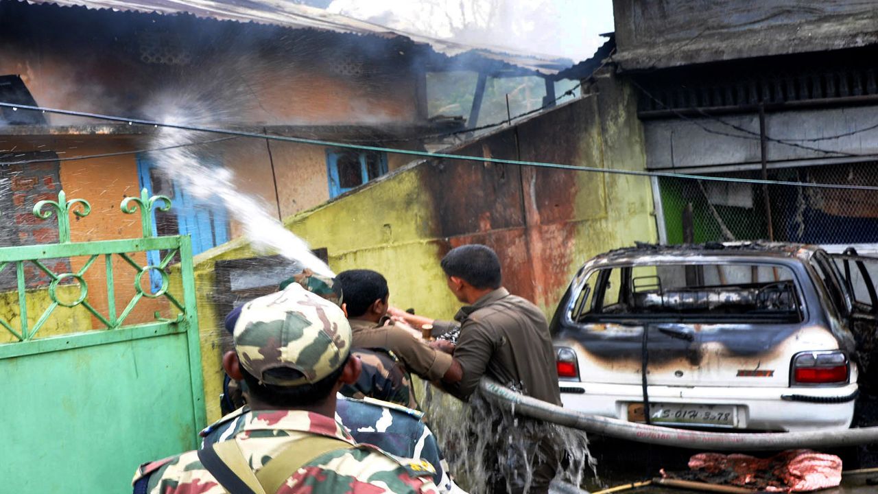 Firefighters put out a fire in a house set alight by rioters in Kokrajhar district in the northeastern state of Assam, India, Tuesday.