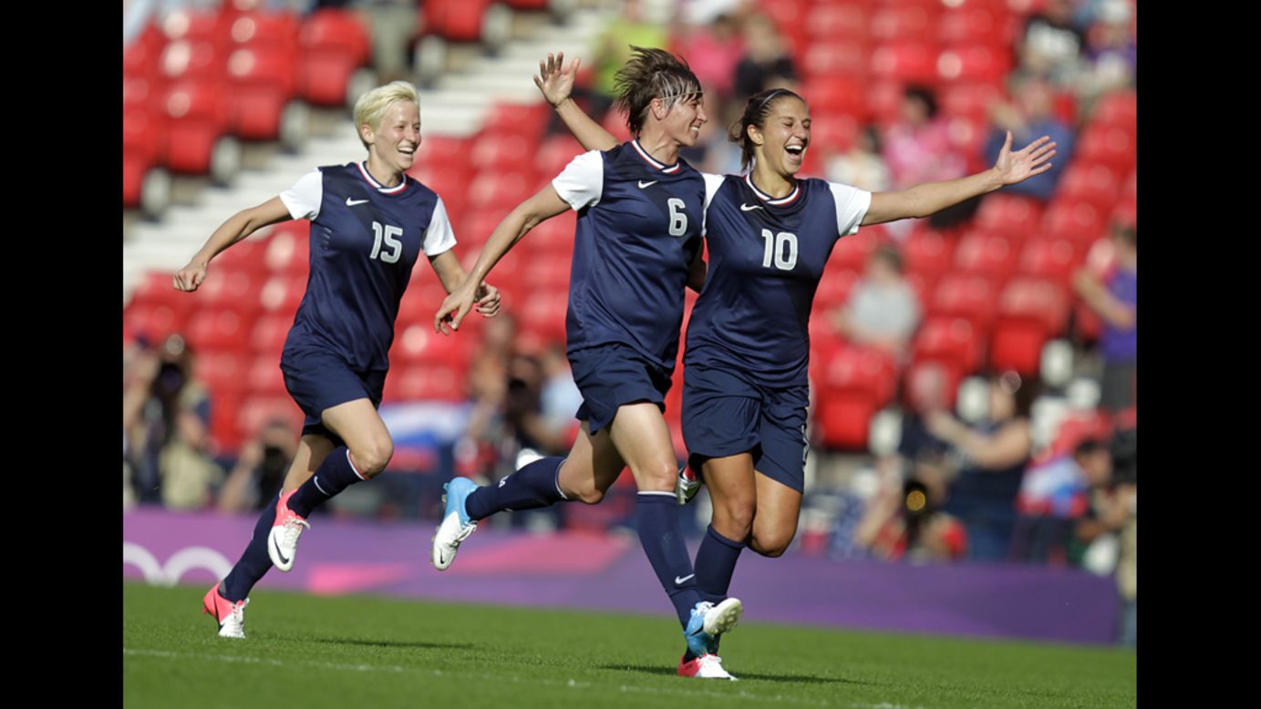 American Carli Lloyd celebrates with teammate Amy Le Peilbet after scoring her team's third goal.