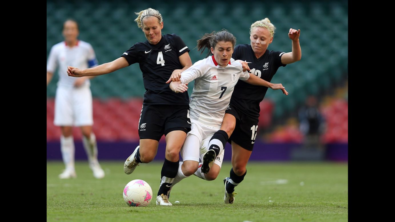 Katie Hoyle, left, of New Zealand and teammate Betsy Hassett challenge Karen Carney of Great Britain during their match in the first round of women's soccer in the London 2012 Olympic Games at Millennium Stadium on Wednesday, July 25, in Cardiff, Wales.