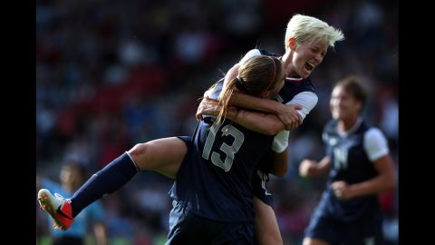 U.S. player Megan Rapinoe jumps on teammate Alex Morgan, No. 13, after Morgan scored during their Group G Olympic women's soccer match against France at Hampden Park in Glasgow, Scotland, on Wednesday, July 25. 