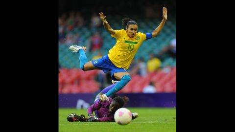Brazil's Marta is in action with Cameroon's goalkeeper Annette Ngo Ndom during the first-round women's football competition at Millennium Stadium on Wednesday.