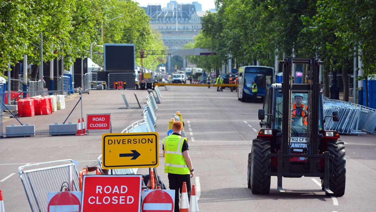 Workers put final touches on the Mall near Buckingham Palace. The Mall closes to traffic during the Games, irritating many Britons.