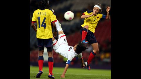 Kim Song Hui of North Korea executes a bicycle kick while challenged by Natalia Ariza of Colombia during the first-round women's football competition at Hampden Park  on Wednesday, July 25, in Glasgow, Scotland.