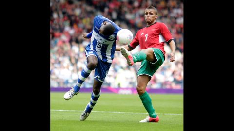Honduras' Jose Velasquez, left, gets challenged by Zakaria Labyad of Morocco during Thursday's match.