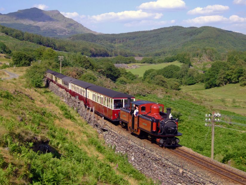 Travelers can take in breathtaking views while riding the Ffestiniog Railway in Wales.