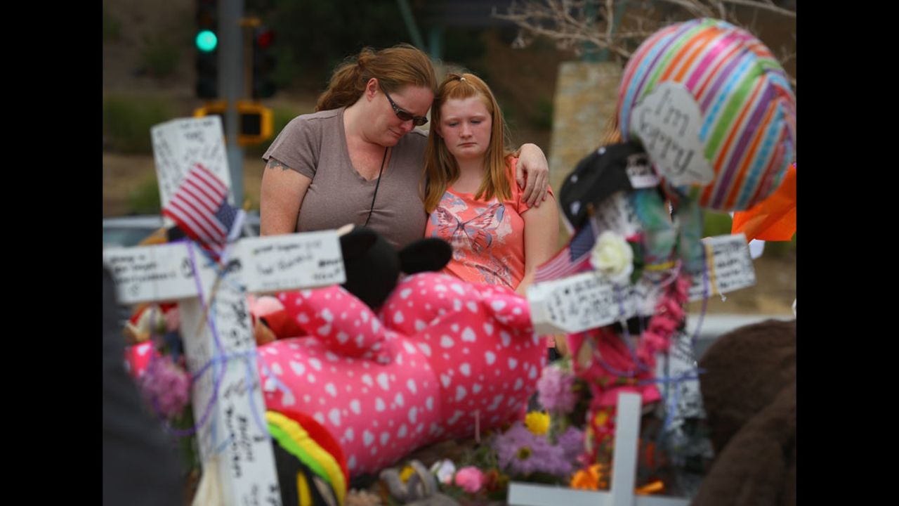 Carrie Hensley, left, and Hailee Hensley mourn together on Wednesday.
