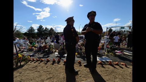 Kevin Flynn, left, Aurora Police top brass division chief, and Cmdr. Jack Daluz visit the makeshift memorial.
