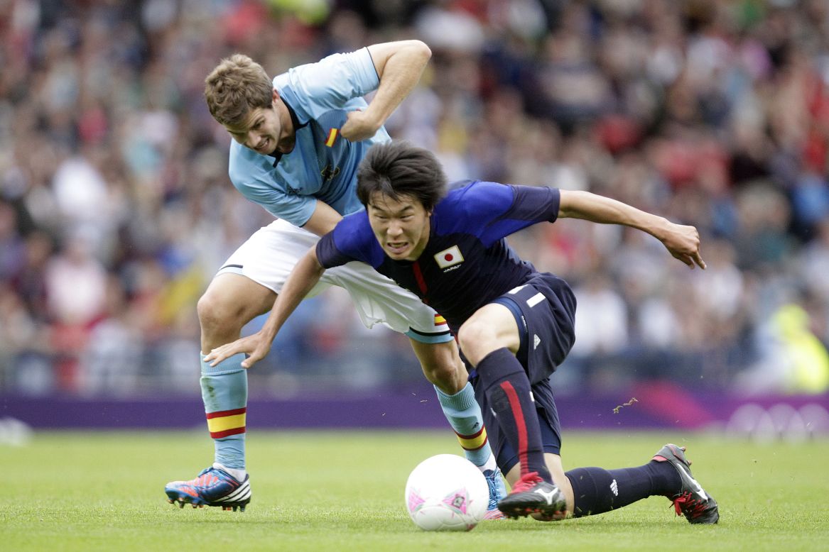 Spain's Inigo Martinez, left, fouls Kensuke Nagai of Japan during the match Thursday.