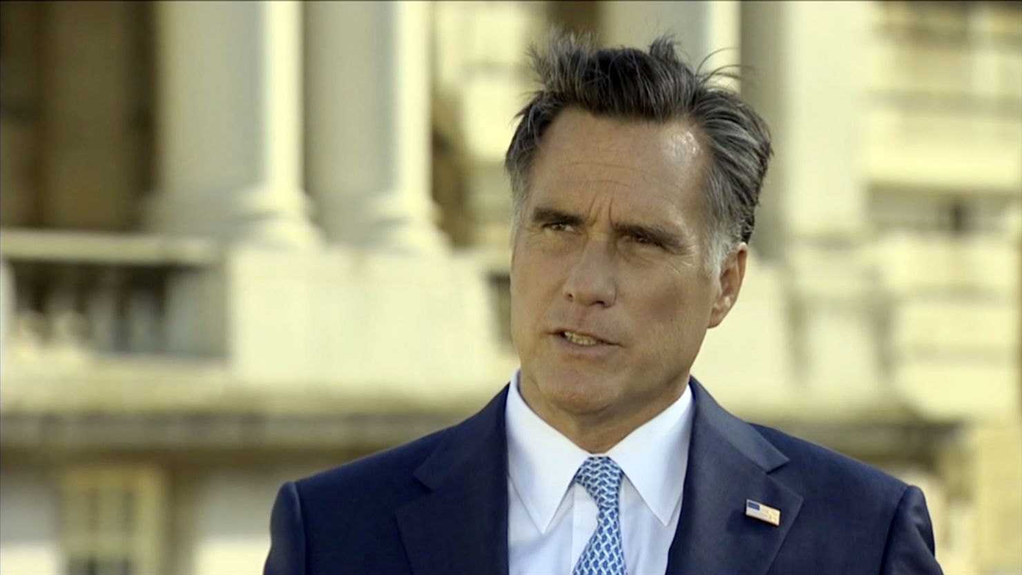 Mitt Romney defends his business career in a CNN interview from London on Thursday.