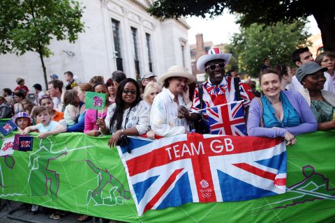 Spectators gather as the Olympic torch is carried from Islington Town Hall on Thursday. London cheered on the torch as it made its way past the city's historic landmarks.