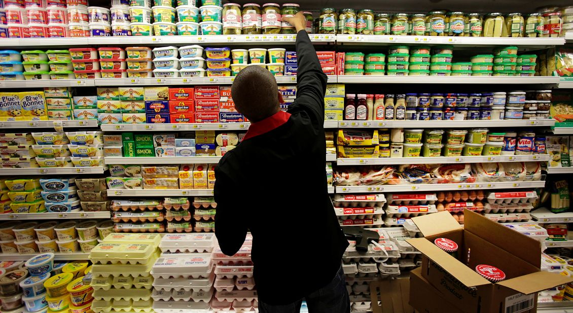 An employee stocks dairy products at a supermarket in New York on Wednesday, July 25. The U.S. Department of Agriculture said prices of dairy products like cheese, milk and eggs are expected to rise 2% to 3% because of the drought.