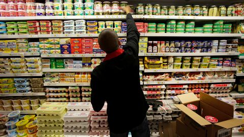 An employee stocks dairy products at a supermarket in New York on Wednesday, July 25. The U.S. Department of Agriculture said prices of dairy products like cheese, milk and eggs are expected to rise 2% to 3% because of the drought.