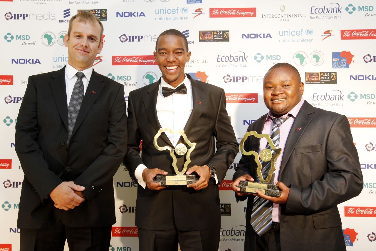 Certainly happy about the win, joint winners Waihiga Mwaura (center) and Jephitha Mwai Mwangi (right) smile after they are awarded the Sport Award for their work on Maasai cricket warriors on Citizen TV in Kenya.