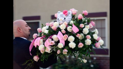 Hello Kitty-themed flowers are sent to shooting victim Micayla Medek's funeral Thursday in Denver.