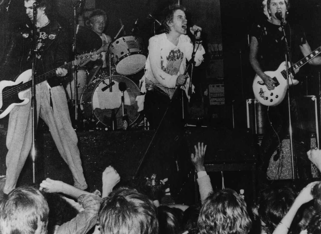 Infamous British punk rock group The Sex Pistols playing live in Copenhagen in 1977. Though banned by the BBC during their time as an act, their song "Pretty Vacant" was included in the Danny Boyle-directed Olympic opening ceremony. 
