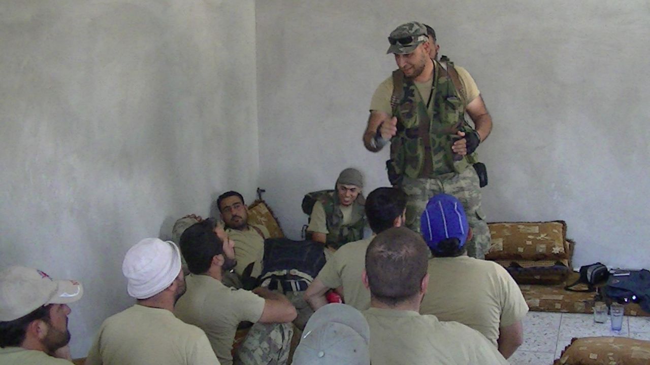  Libyan revolution veteran Al-Mahdi al-Harati (standing) training members of the Liwa al-Umma to fight in Syria.