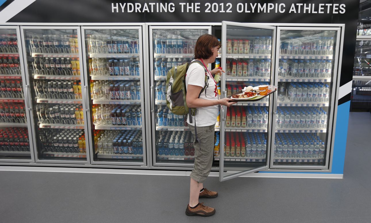 A Canadian team member takes a drink from a refrigerator in the main dining hall in the Olympic Village ahead of the Games on July 24.