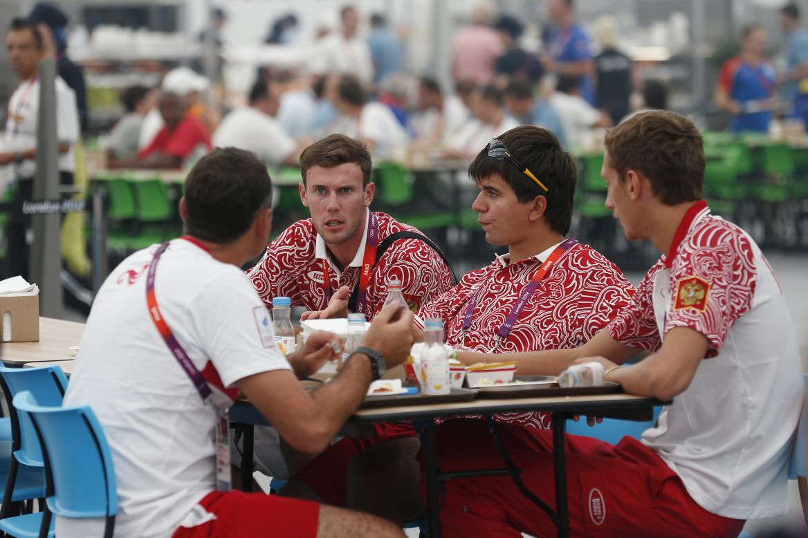 Team members from Russia eat in the main dining hall inside the Olympic Village.