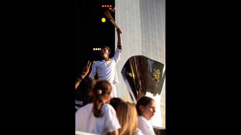 Musician Tyler Rix lights the Olympic cauldron during the torch relay finale concert in London's Hyde Park on Thursday, July 26.