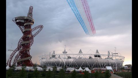 The Red Arrows fly over Olympic Stadium before the opening ceremony.