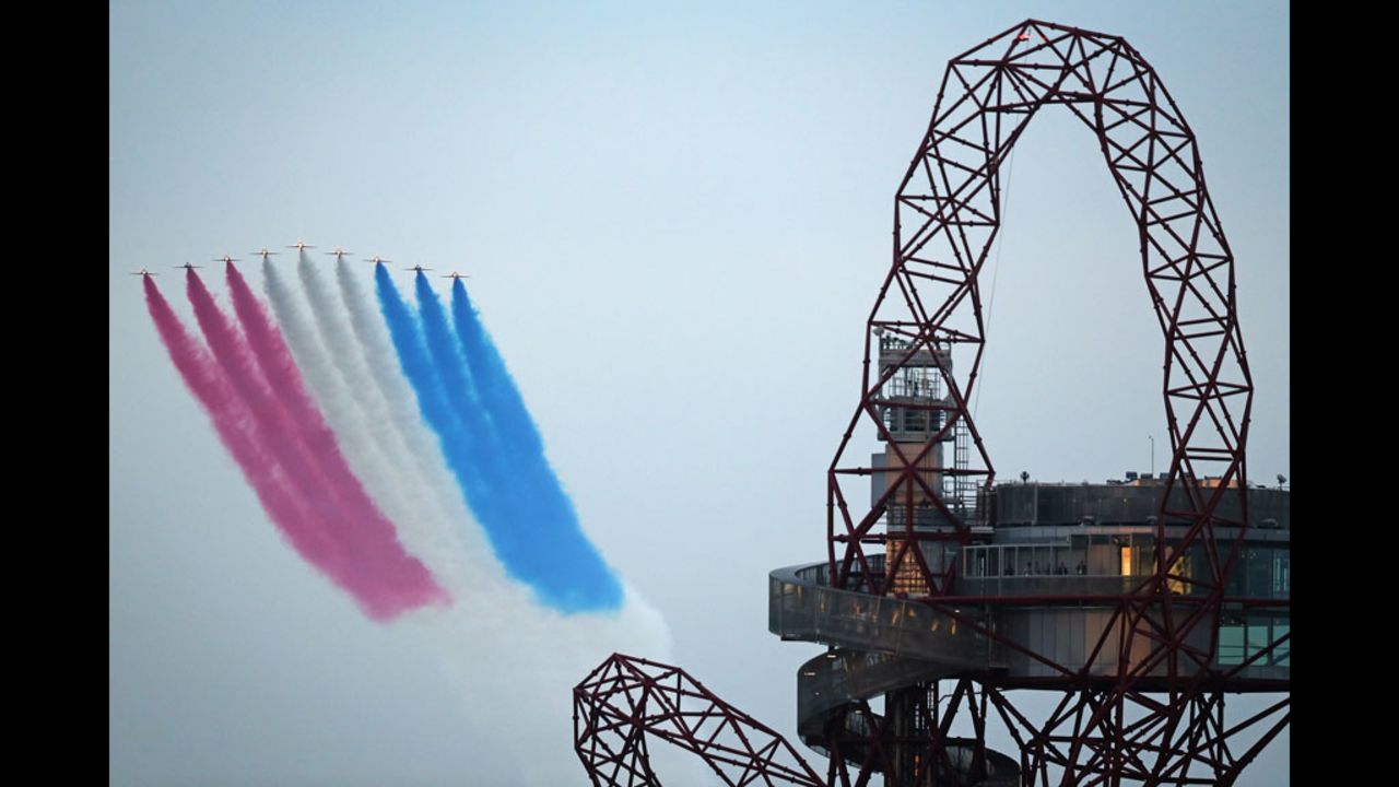 The Red Arrows fly over the Olympic Stadium and the ArcelorMittal Orbit Tower.