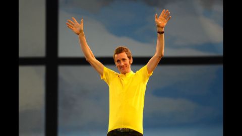 Bradley Wiggins, the first British winner of the Tour De France cycle race, waves to the audience.