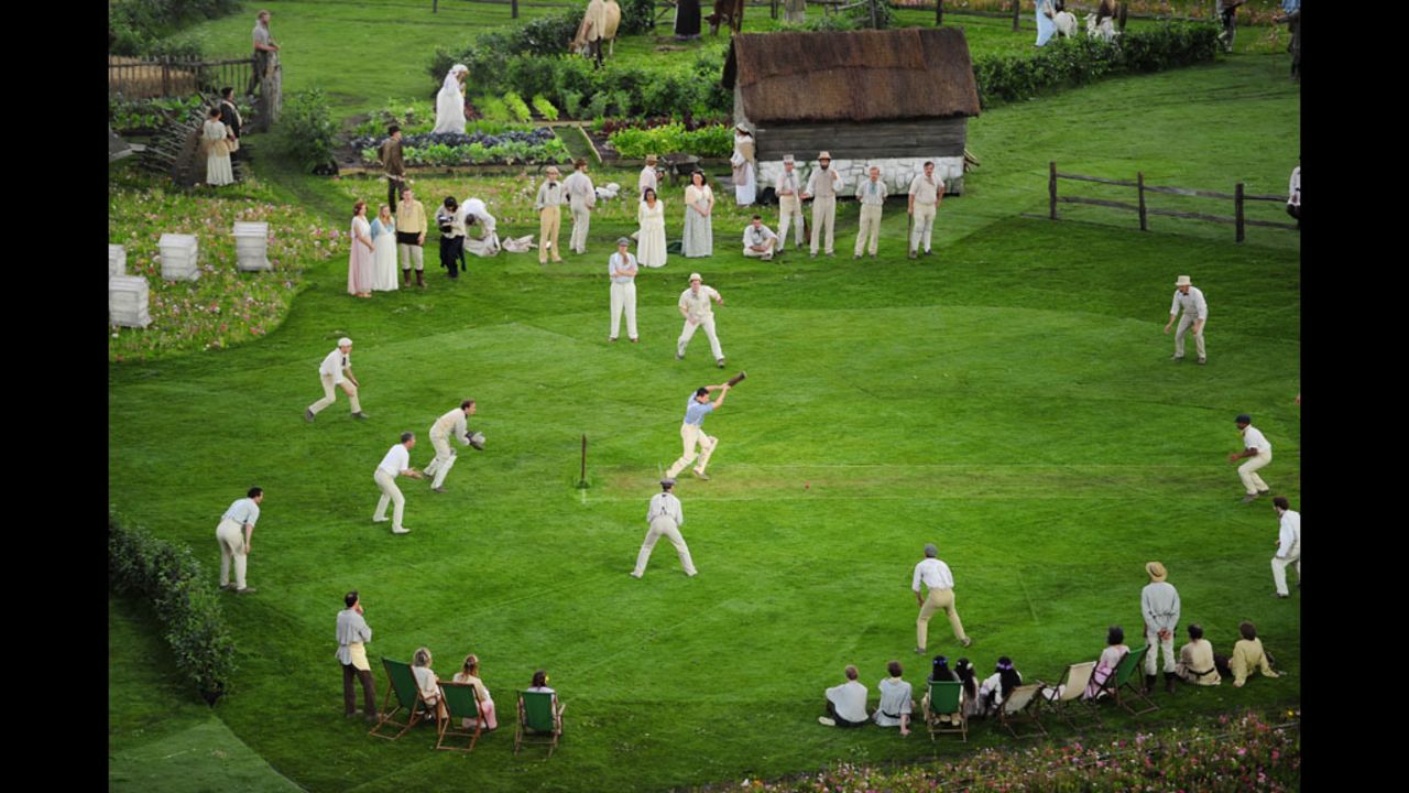 Cricketers play on the pitch during the preshow.
