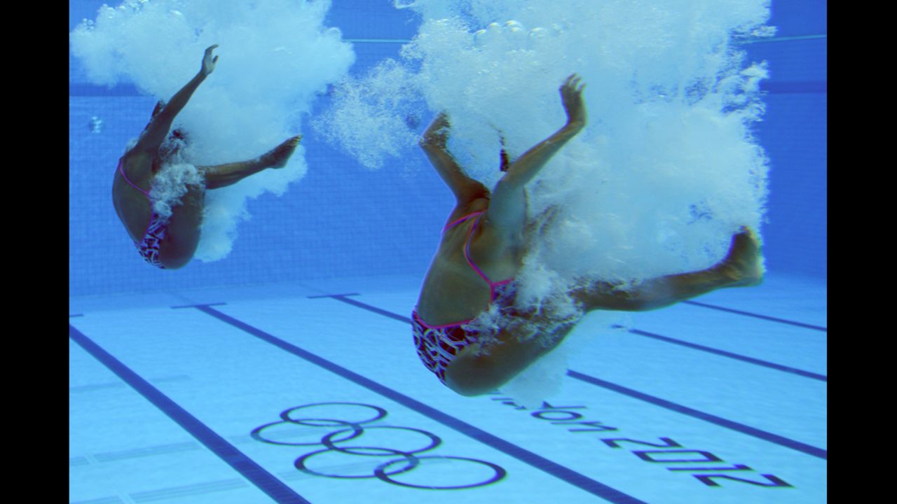 Olympians will compete over anything. Here, two divers have an exhaling contest.