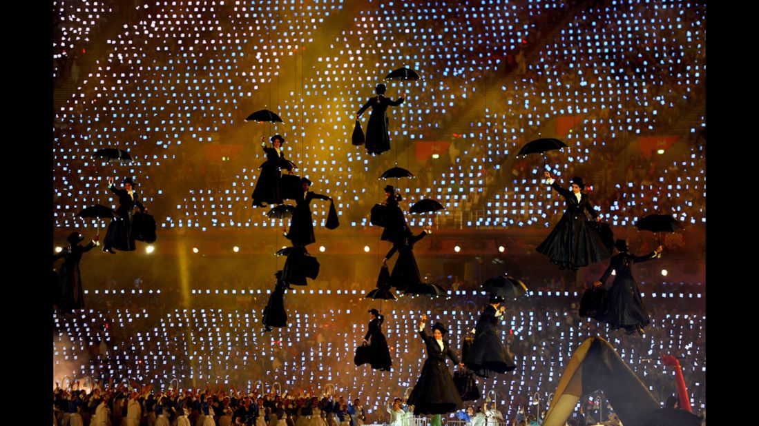 Performers float with umbrellas as they play the role of Mary Poppins.