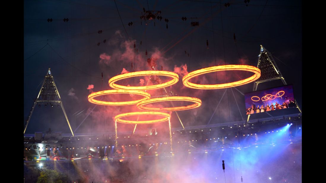 Freshly "forged" Olympic Rings fly above the chimneys during The Age of Industry scene.
