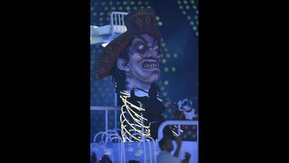Giant pictures depicting villains of British literature, including Captain Hook from "Peter Pan," are displayed during the opening ceremony.