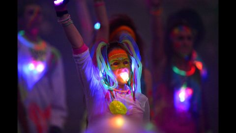 An artist performs with a glowing pacifier during the opening ceremony.
