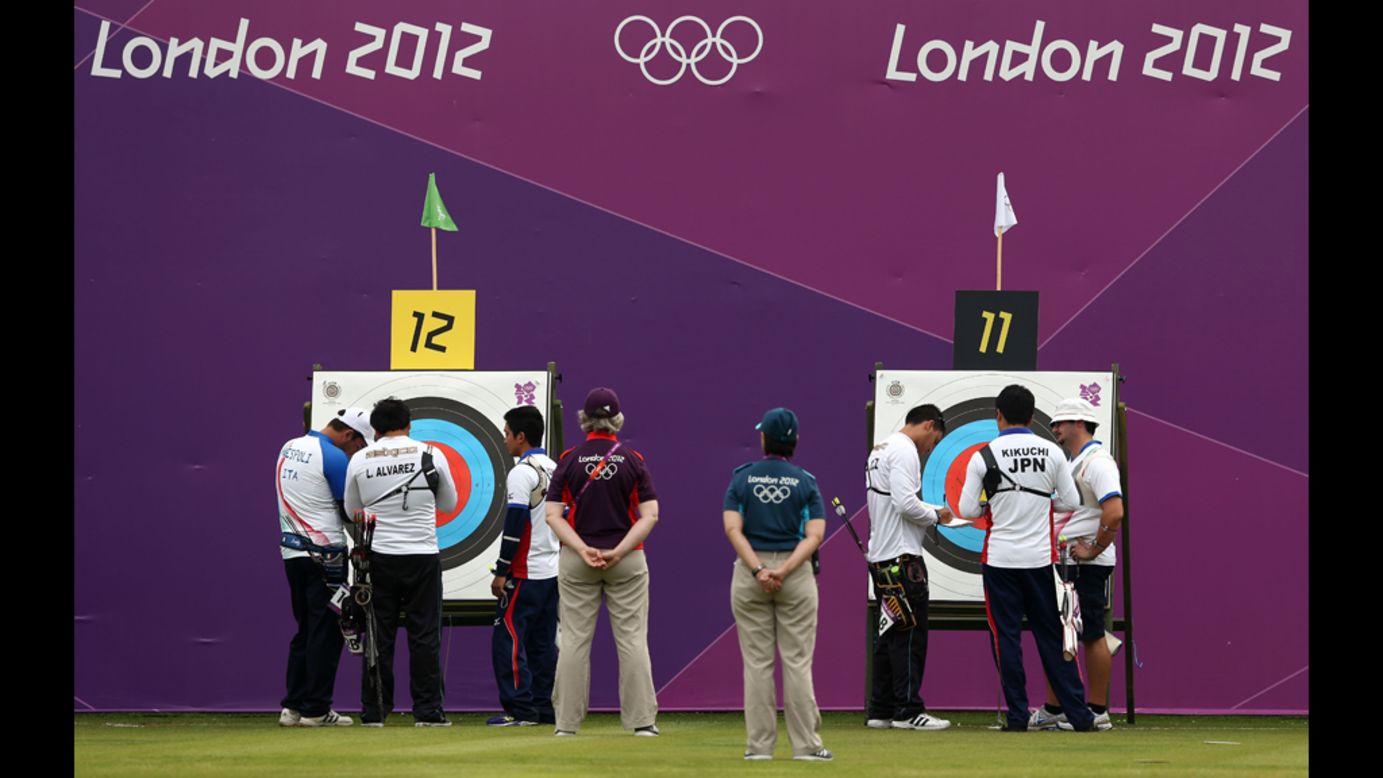 Competitors inspect targets Friday during the Archery Ranking Round at the Lord's Cricket Ground in London.