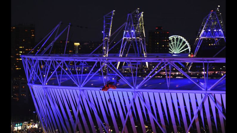 A parachutist lands outside the Olympic Stadium.