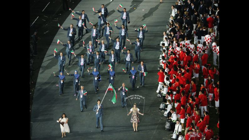 Ali Mazaheri of the Iran Olympic boxing team carries his country's flag.