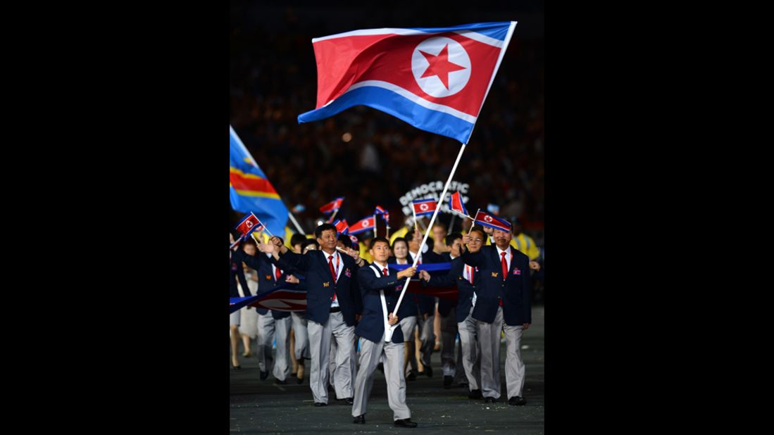 Song-Chol Pak of the North Korea Olympic team carries his country's flag.