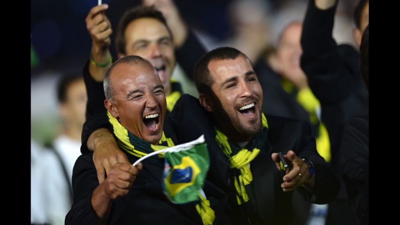 Members of Brazil's delegation hold their national flag as they walk during the opening ceremony.