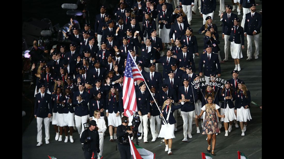 Mariel Zagunis of the United States Olympic fencing team carries her country's flag.