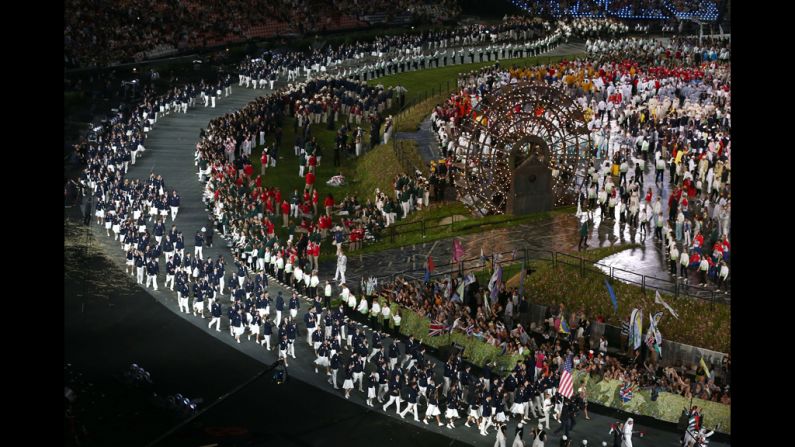 Fencer Mariel Zagunis leads the U.S. Olympic  team around the stadium.