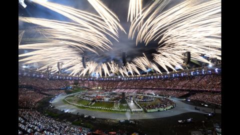  Fireworks burst above the stadium during the opening ceremony. 