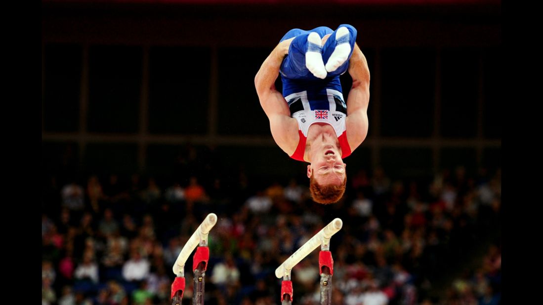 British gymnast Daniel Purvis performs on the artistic gymnastics men's parallel bars.