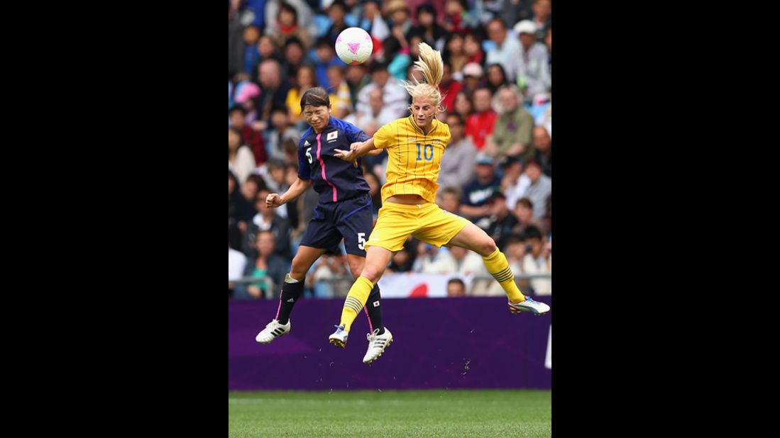 Japan's Aya Sameshima and Sofia Jakobsson of Sweden compete for the ball during a women's first-round soccer game.