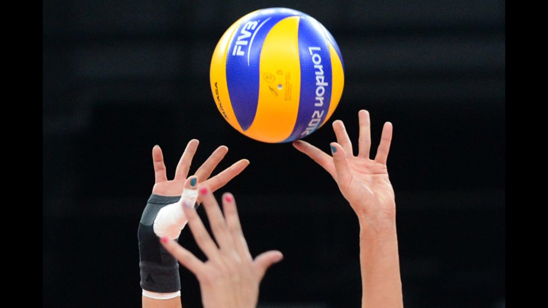 Serbia's Maja Ognjenovic, right, passes the ball during a women's volleyball match between Serbia and China.