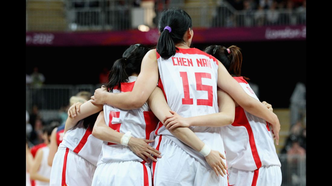 China's Nan Chen, No. 15, huddles with teammates.